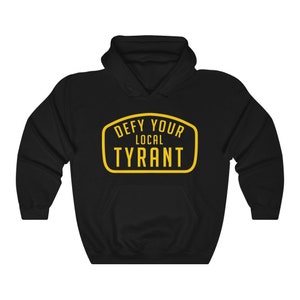 May include: Black hooded sweatshirt with a yellow graphic that says "Defy Your Local Tyrant" in a vintage-style badge.
