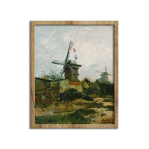 May include: A framed print of a landscape painting featuring two windmills under a cloudy sky. The artwork has a rustic aesthetic, with visible brushstrokes and a muted color palette of greens, browns, and blues. The frame is made of light-colored wood.