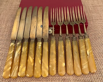 A beautiful antique set of 12 French brass coloured vintage fruit utensils  and forks with yellow marble effect Bakelite handles