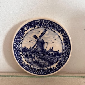 A beautiful Delft Blue Dutch  Holland china hand painted blue and white trinket dish with traditional Dutch village scene