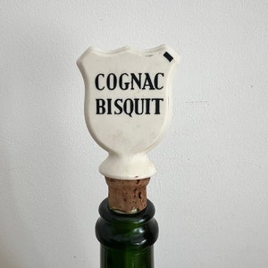 A retro French Cognac Bisquit  plastic and cork bottle stopper