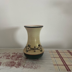A lovely  Jersey Pottery ceramic vase with an emerald green lower part and a decorative leaf garland around the lower part