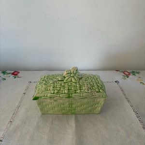 A vintage Art Deco era lime green Majolica  1030 England ceramic lidded butter dish with a basket weave, floral design
