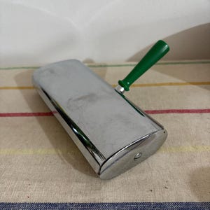 A beautiful antique  French  chrome plated table crumb brush sweeper with a green detachable bakelite handle