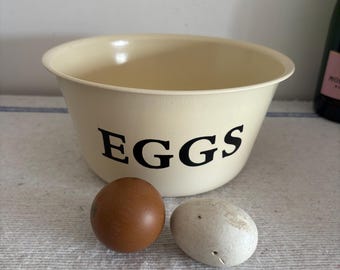 An 8" diameter vintage-style painted off white metal egg bowl or basin, designed to store eggs or   tasks related to eggs, whisking