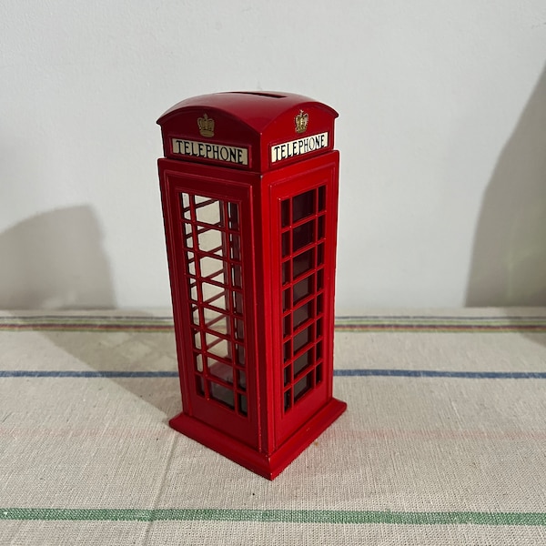 A vintage replica  British  die cast metal  red telephone money box, piggy bank