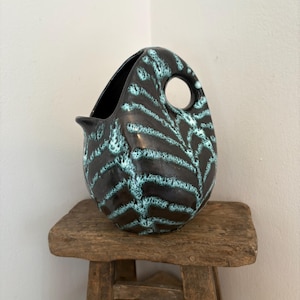 A vintage minimalist Hungarian ( foreign) 1950s Fat Lava style 7.5" tall ceramic pitcher vase with  black glaze and teal leaf pattern (4784)