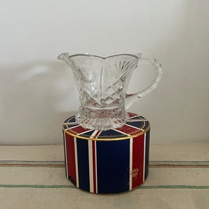 A small patterned pressed  clear glass  Art Deco jug or creamer