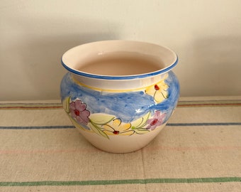 A  pretty vintage hand painted  medium sized indoor  planter with a multi-coloured floral pattern and no drainage hole
