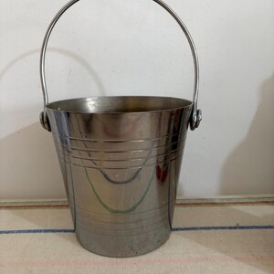 A  French retro polished stainless steel ice bucket with handle