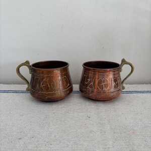 A lovely  pair of antique hand made copper mugs with brass handles - perfect for cocktails