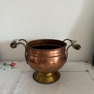 French vintage copper and brass planter with blue and white decorative floral porcelain handles