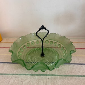 A lovely Art Deco round fluted edge lime  green glass dish bowl with central black handle
