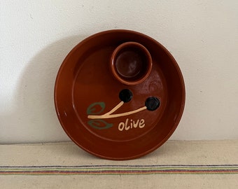 A generous sized Siaki vintage  rustic glazed terracotta clay dish for serving olives with drinks with a place for stones
