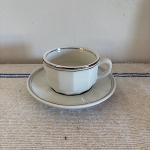 Exquisite French Vintage Apilco coffee tea cup, saucer made from white porcelain with silver trim