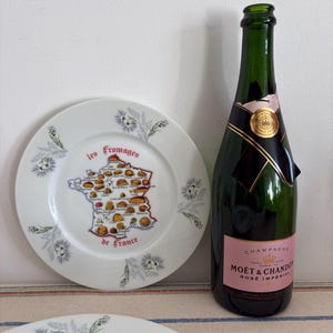 Ensemble de cinq assiettes à fromage françaises Table & Decor en porcelaine avec une carte de France indiquant l'origine du fromage
