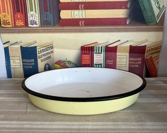 A vintage  oval  pale yellow  French enamel baking tray dish with black rim