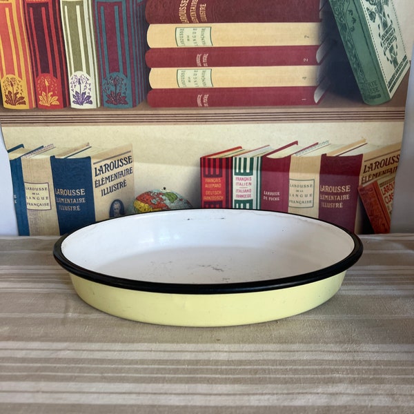 A vintage  oval  pale yellow  French enamel baking tray dish with black rim