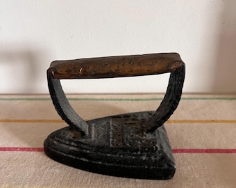 A lovely British cast iron antique sad iron, ideal for use as a book end or door stop