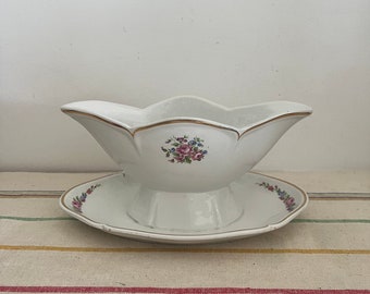 An imposing beautifully elegant white  china floral decor gravy boat, sauce boat, mayonnaise server with attached saucer