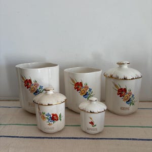 A rare beautiful Moisson semi - porcelain Art Deco floral set of 5 French Vintage China canisters with names  in gold ( missing 2 lids)
