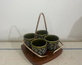 A rare vintage  Wynncraft   teak and brass stand with four classic  Crown Devon bottle green  ceramic egg cups