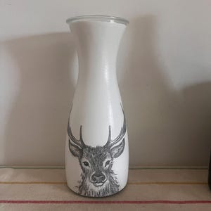 A quirky upcycled festive stage  white painted glass carafe vase