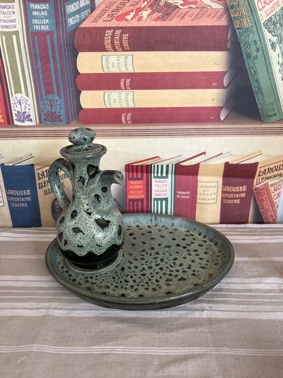 A vintage Fosters Pottery green honey comb lava oil or vinegar jug 