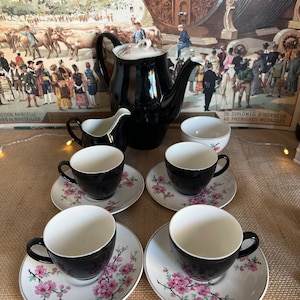 An unusual retro Johnson Bros  pink blossom and black  coffee set of coffee pot, creamer sugar bowl and  four expresso cups and saucers