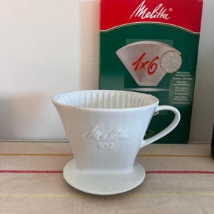 A Classic Retro Melitta drip coffee filter paper holder funnel with handle marked  size  &#39;102&#39; for pour over drip coffee making