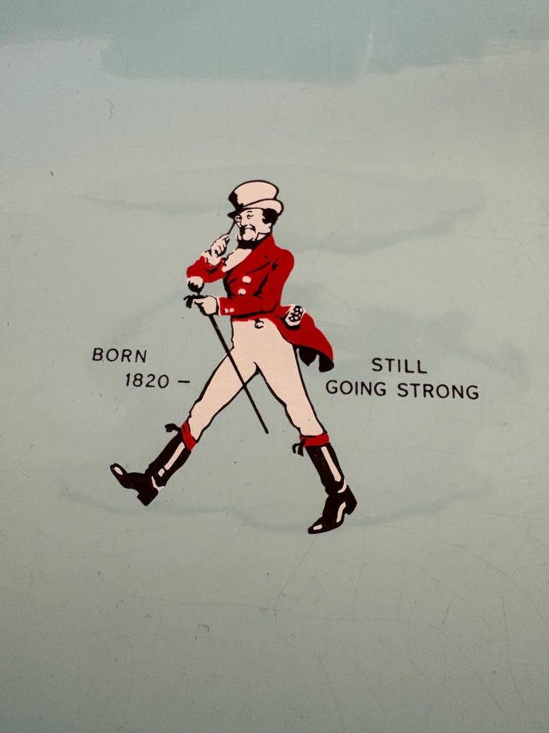 May include: An illustration of a man in a top hat and red coat walking with a cane. The text "BORN 1820 - STILL GOING STRONG" is below the illustration.
