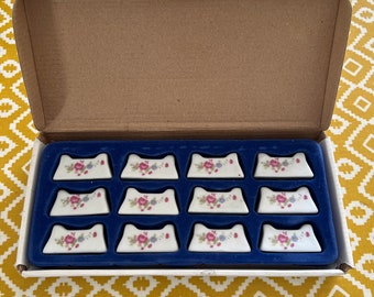A very unusual French vintage boxed set of 12 china floral design cutlery rests