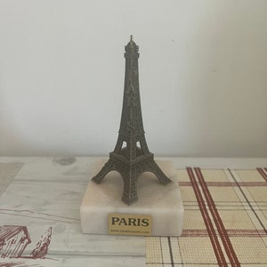 A retro French vintage souvenir  brass Eiffel tower on a marble base