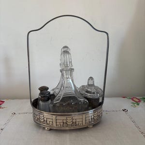 A charming French retro  six  piece cruet set ( Salt, pepper, oil, vinegar mustard) in a silver plated  tray stand with handle