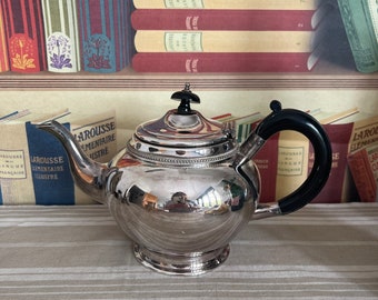 An  antique Victorian  EPBM silver plated  teapot with a bakelite handle and finial and  hinged lid