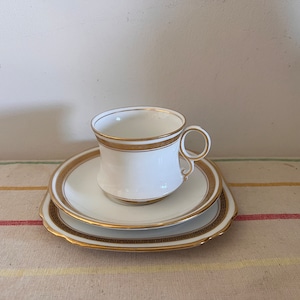 A vintage Royal Albert Crown China  white and gold trio  cup,  saucer and plate