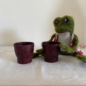 A pair of  retro functional utilitarian mottled browny red plastic British made egg cups