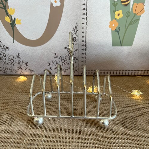 An exquisite rare large silver plated six retailer slice toast rack perfect to brighten up your breakfast table