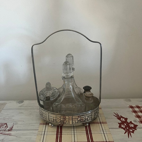 A charming French retro  six  piece cruet set ( Salt, pepper, oil, vinegar mustard) in a silver plated  tray stand with handle