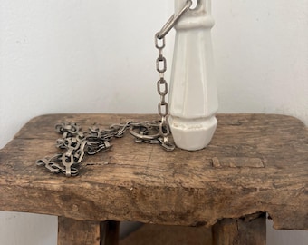 An antique French white ceramic light pull handle /high-level toilet cistern pull with original stainless steel chain