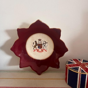 A white  and burgundy dish from the Royal Victoria range by  Wade to commemorate The Queens  Coronation 1953 with the Royal Coat of Arms