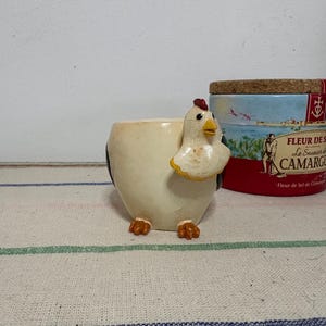A substantial weight  beautifully hand painted  collectible chicken egg cup with a fun sprung wobble  head