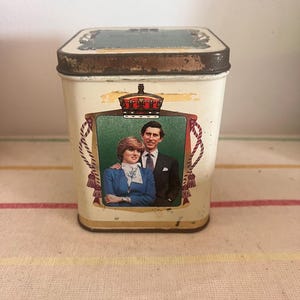 A metal tea caddy container commemorating the marriage of Prince Charles and Lady Diana Spencer 1981