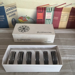 A pretty boxed set of 6 Florantal ornate  silver plated  napkin holders to bring the height of sophistication to your dining table