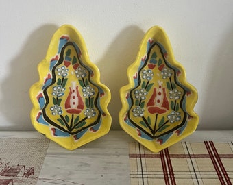 A pair of beautifully hand painted Mexican pottery leaf shaped  yellow snack trinket dishes