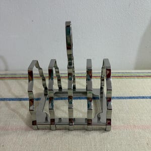 A vintage Olde Hall polished stainless steel four slice toast rack to brighten up your breakfast table