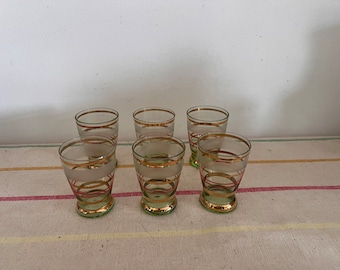 An original 1950s set of 6 French  gold  rimmed  coloured shot glasses