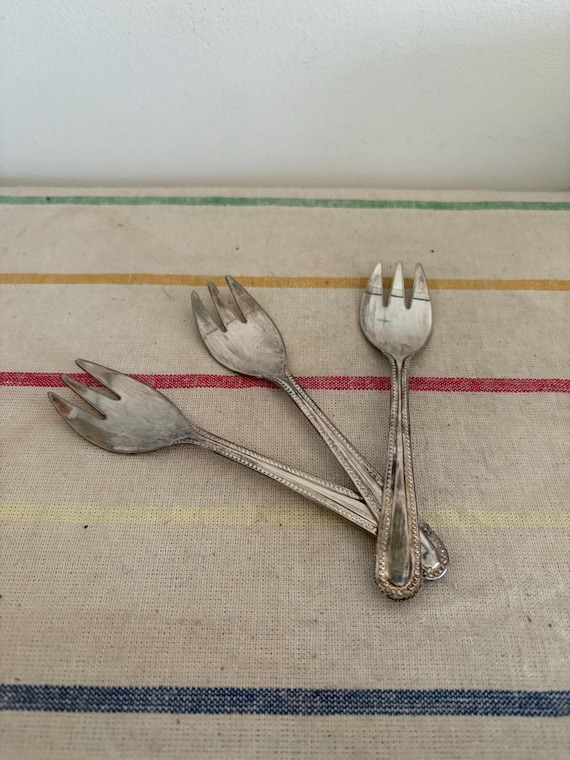 A Set of Three Mayell Silver Plated Oyster Forks to Replicate the