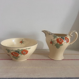 A stunning Myott Art Deco hand painted matching  milk jug or creamer and sugar bowl