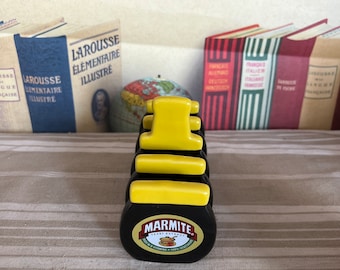 A quirky vintage  Marmite black and yellow china four slice  toast rack